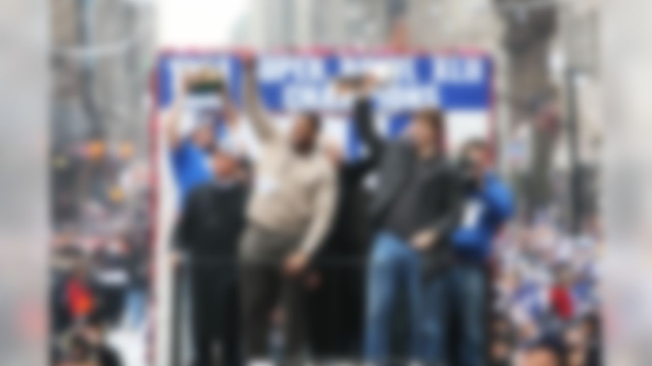 NEW YORK - FEBRUARY 05: Mayor of New York Michael Bloomberg (L), Michael Strahan (C) and Eli Manning of the New York Giants ride in a float along Broadway, also known as "The Canyon of Heroes" during Super Bowl XLII victory parade in New York City. (Photo by Al Bello/Getty Images)
