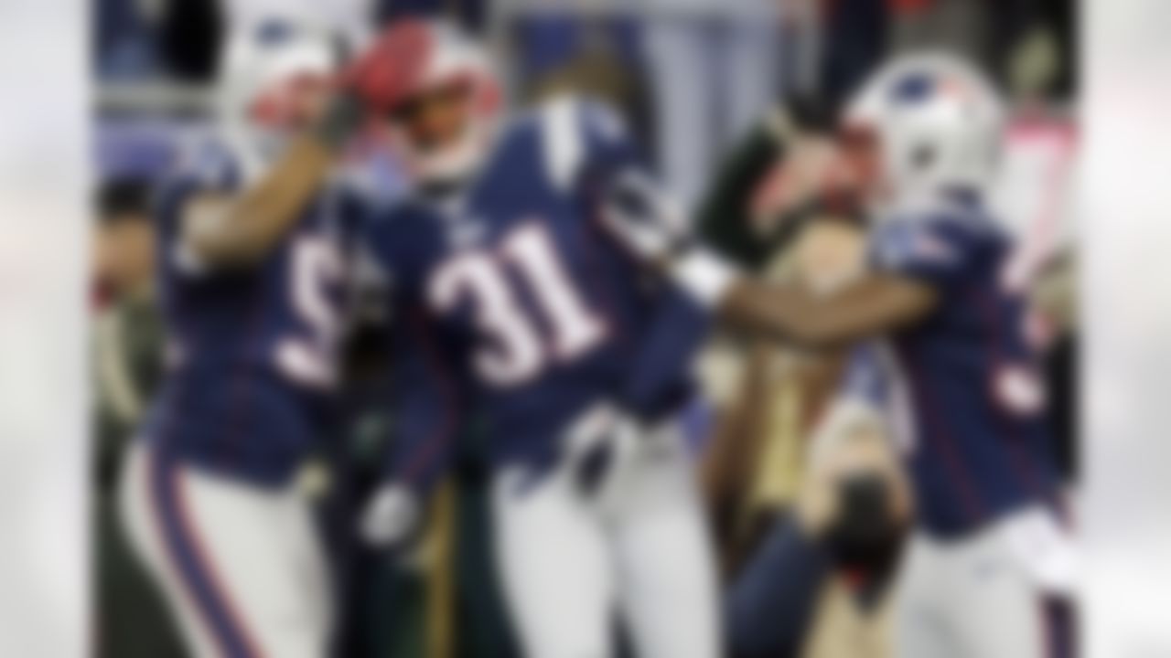 New England Patriots cornerback Aqib Talib (31) is congratulated by outside linebacker Jerod Mayo, left, and cornerback Alfonzo Dennard, right, after his interception that he ran back for a touchdown against the Indianapolis Colts in the second quarter of an NFL football game at Gillette Stadium in Foxborough, Mass., Sunday, Nov. 18, 2012. (AP Photo/Charles Krupa)