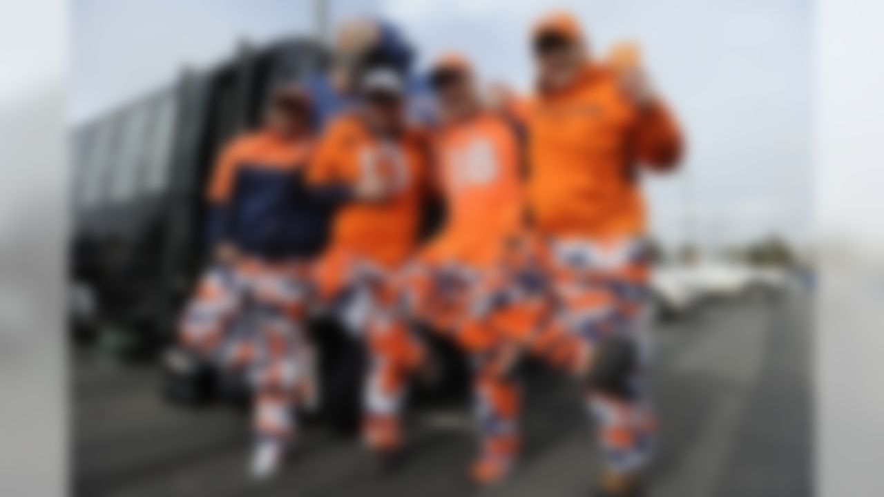 Denver Broncos fans show off their team apparel while tailgating before the NFL divisional playoff game against the Indianapolis Colts at Sports Authority Field in Denver, CO January 11, 2015 (AP Photo/ Eric Bakke)