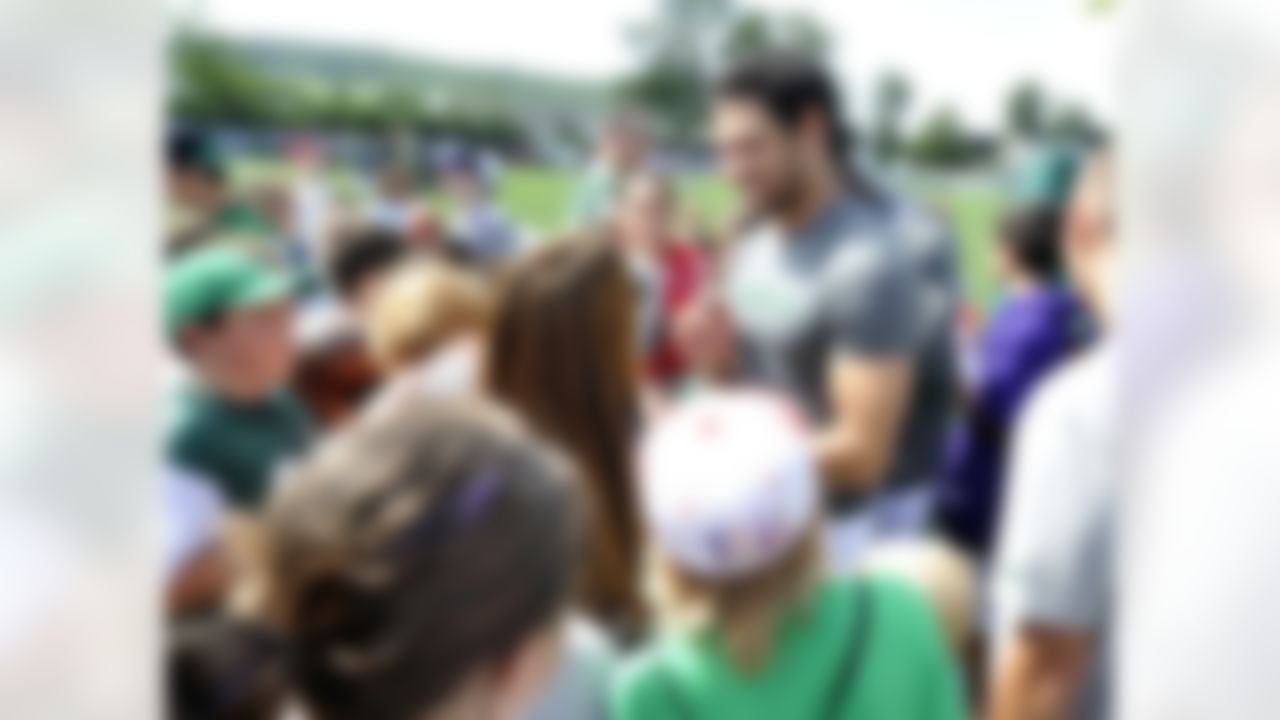 New York Jets quarterback Mark Sanchez greets fans and signs autographs at NFL football training camp on Sunday, July 29, 2012, in Cortland, N.Y. (AP Photo/Bill Kostroun)