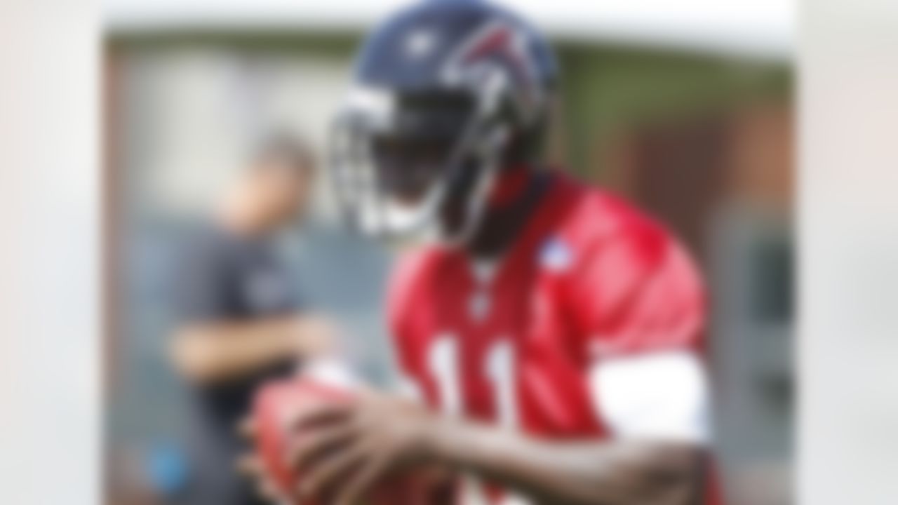 Atlanta Falcons receiver Julio Jones laughs with teammates as he catches a ball during NFL football training camp in Flowery Branch, Ga., Friday, July 27, 2012. (AP Photo/John Bazemore)