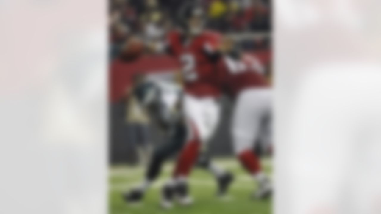 Atlanta Falcons quarterback Matt Ryan (2) looks for a receiver as Philadelphia Eagles defensive end Jason Babin (93) pursues in the second half of an NFL football game at the Georgia Dome in Atlanta on Sunday, Sept. 18, 2011. (AP Photo/John Amis)