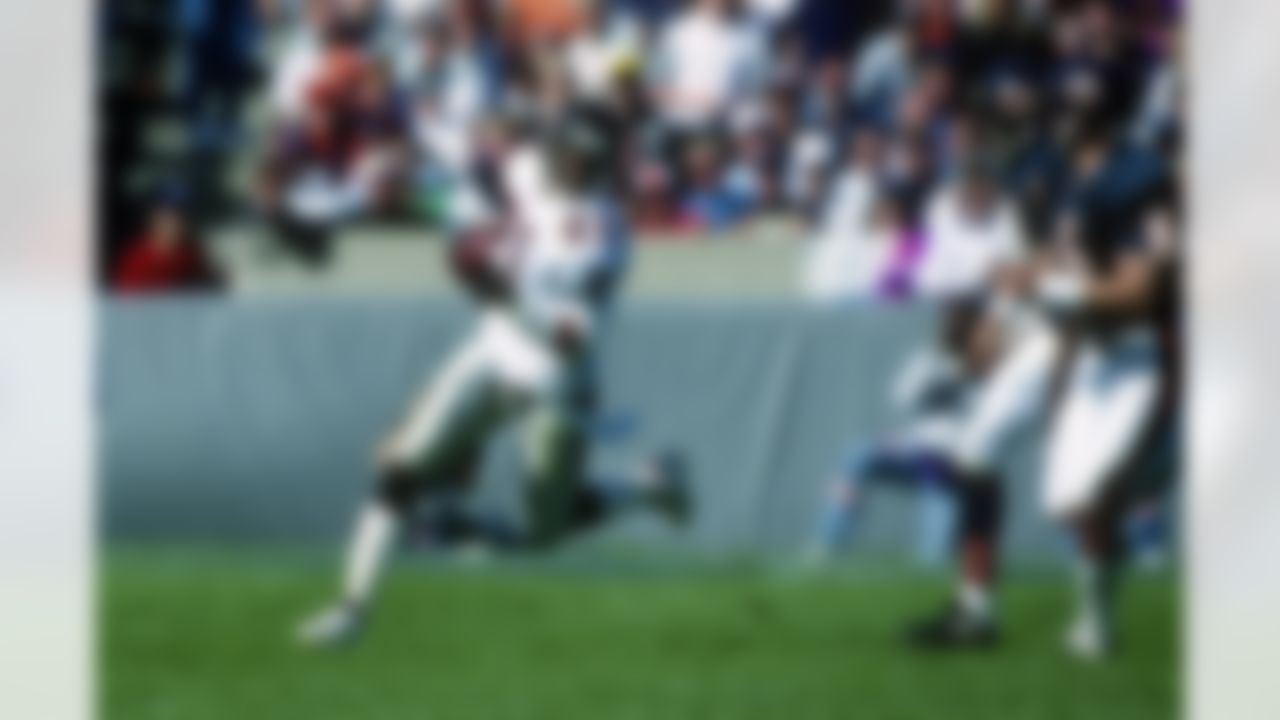 Atlanta Falcons cornerback Deion Sanders (21) gets chased while he runs with the ball during the NFL game against the Chicago Bears on September 27, 1992 in Chicago, Illinois. The Bears won the game 41-31. (AP Photo/Paul Spinelli)