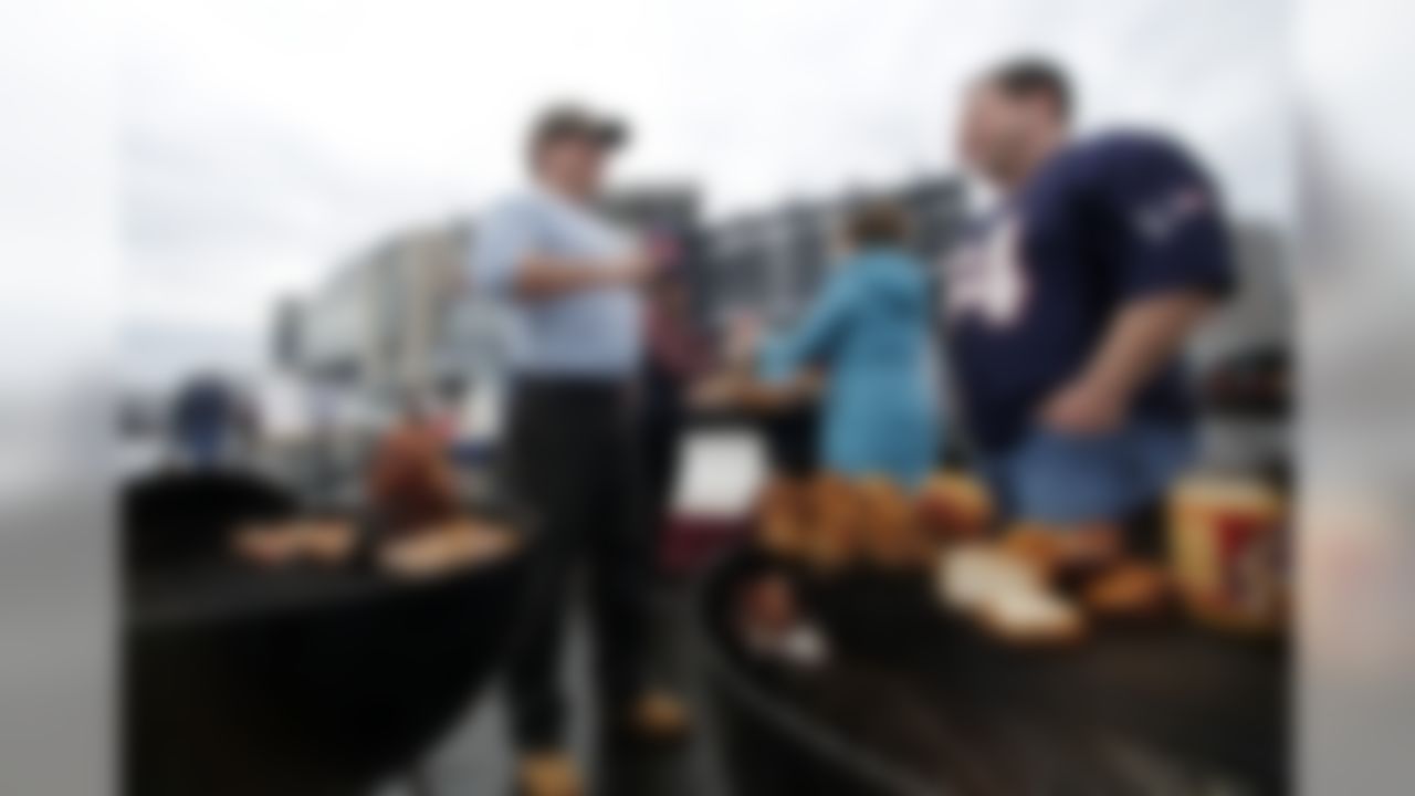 David and Chris Ritchie grill lunch in the parking lot of Gillette Stadium before an NFL football game between the New England Patriots and the Buffalo Bills Sunday, Dec. 28, 2014, in Foxborough, Mass. (AP Photo/Elise Amendola)