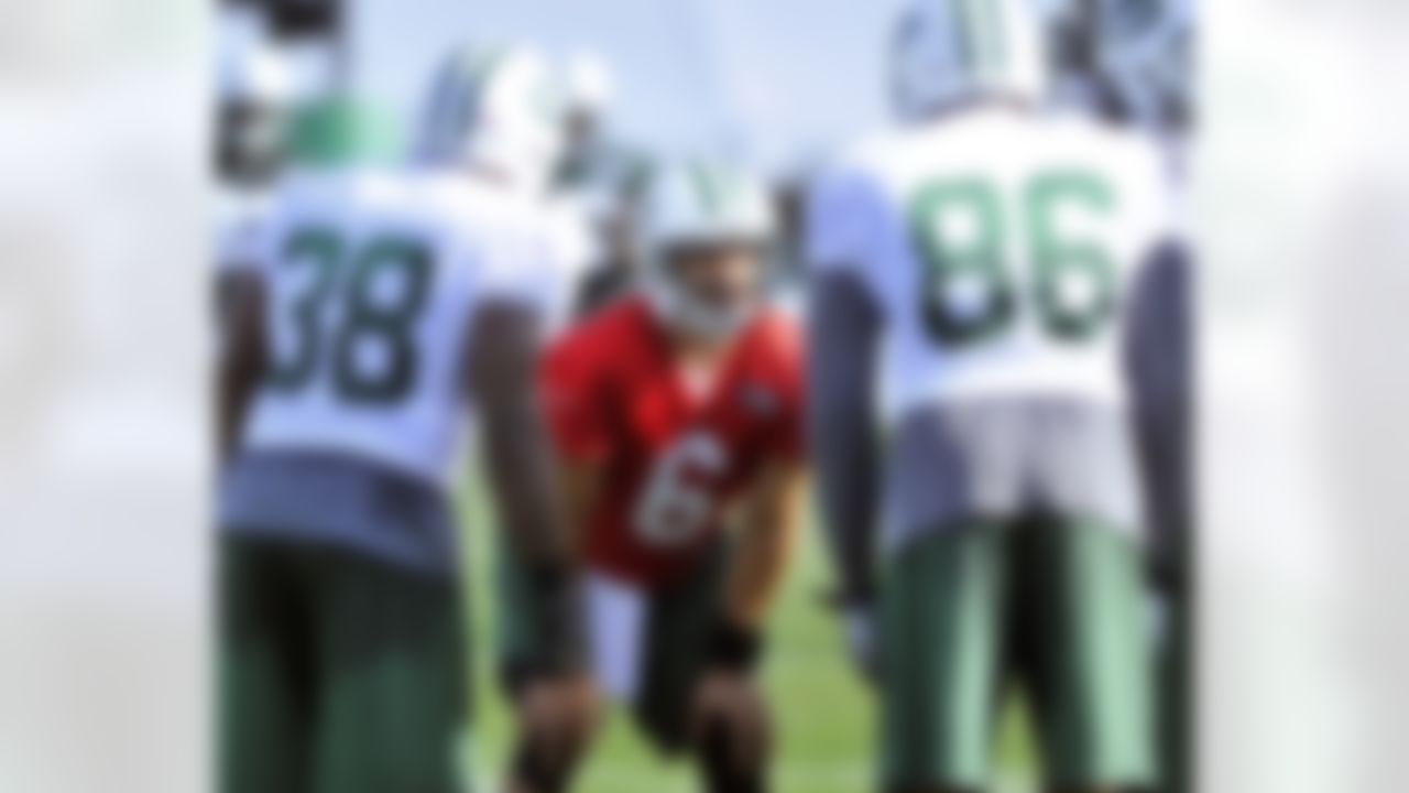 New York Jets quarterback Mark Sanchez (6) calls a play in the huddle on opening day of their NFL football training camp Friday, July 27, 2012 in Cortland, N.Y. (AP Photo/Bill Kostroun)