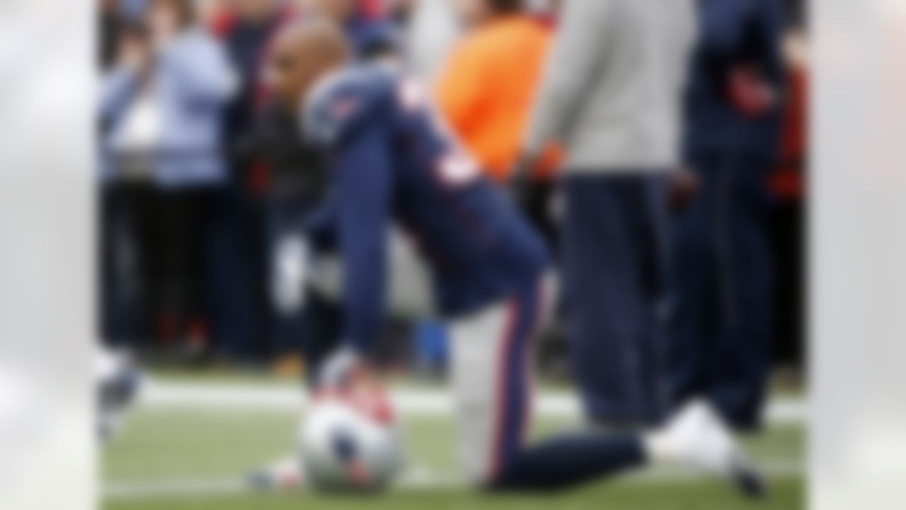 New England Patriots cornerback Aqib Talib kneels on the field before an NFL football game against the Cleveland Browns Sunday, Dec. 8, 2013, in Foxborough, Mass. (AP Photo/Elise Amendola)