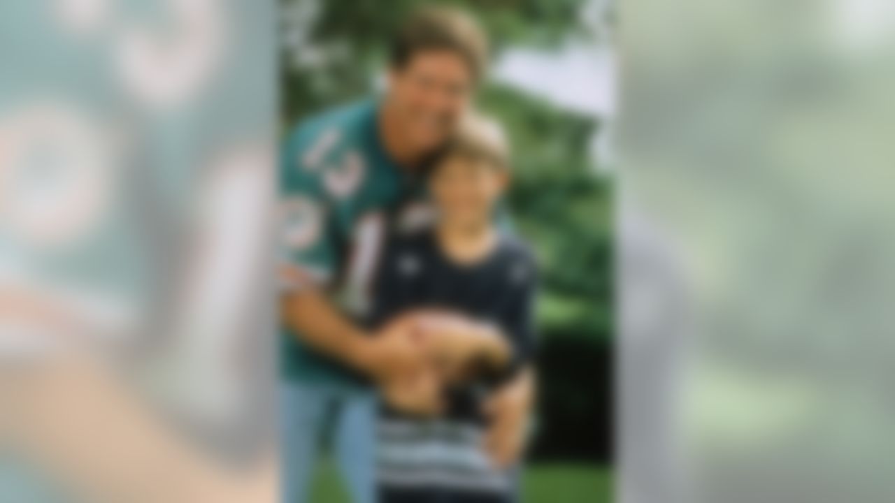 MIAMI, FL - MARCH 30: Quarterback Dan Marino #13 of the Miami Dolphins poses with his son Daniel for their NFL ProLine Profile card, on March 30, 1993 in Miami, Florida. (AP Photo/NFL Photos)