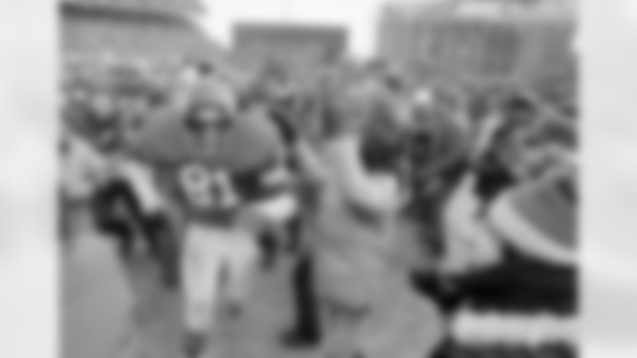 Minnesota Vikings defensive end Carl Eller (81) leads the victorious through happy fans after they beat the Los Angeles Rams for the NFC championship, 24-13, at Bloomington on Sunday, Dec. 26, 1976. (AP Photo)