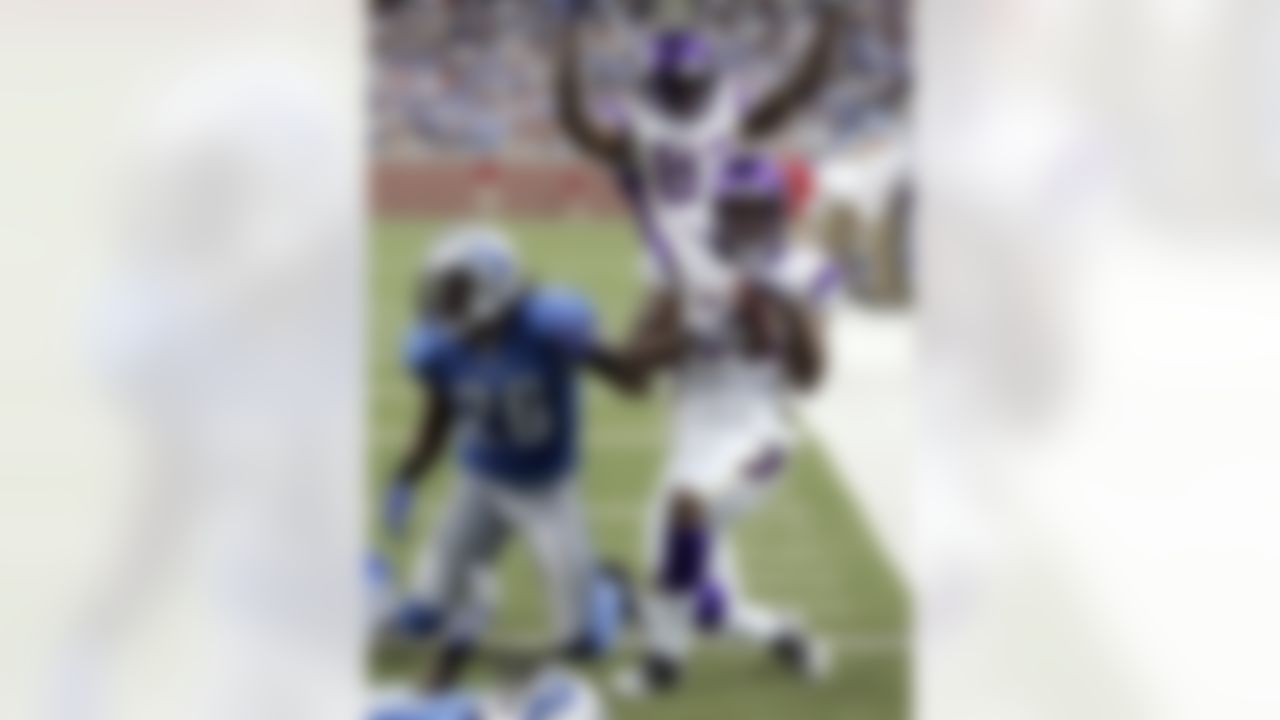 Minnesota Vikings wide receiver Percy Harvin, front, celebrates with teammate Bernard Berrian, rear, after scoring a touchdown against Detroit Lions safety Louis Delmas (26) in the fourth quarter of an NFL football game Sunday, Sept. 20, 2009 in Detroit. The Vikings defeated the Lions 27-13. (AP Photo/Duane Burleson)