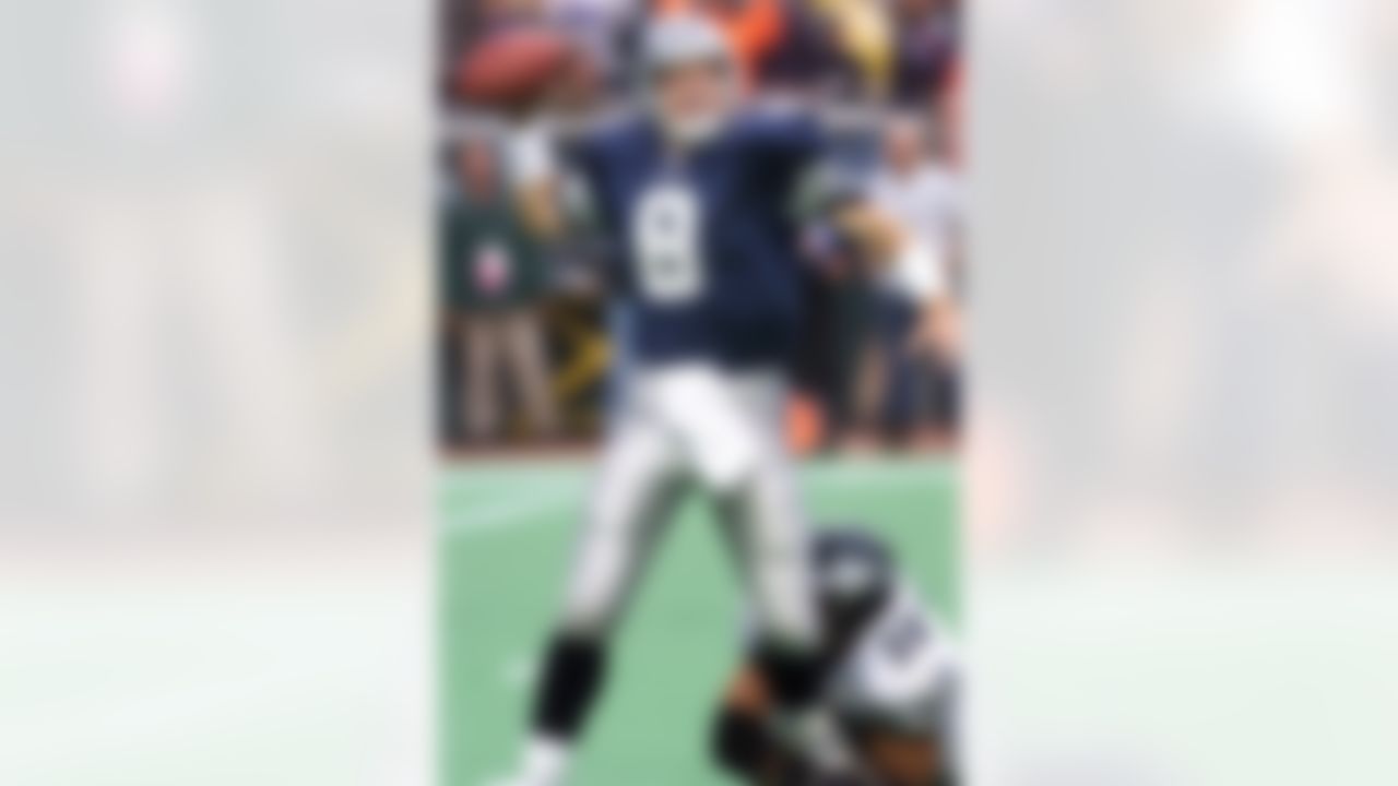 Dallas Cowboys quarterback Troy Aikman looks to pass as Philadelphia Eagles' Mike Mamula hangs on during the fourth quarter, Sunday, Oct. 10, 1999, in Philadelpia. The Eagles won 13-10. (AP Photo/Rusty Kennedy)