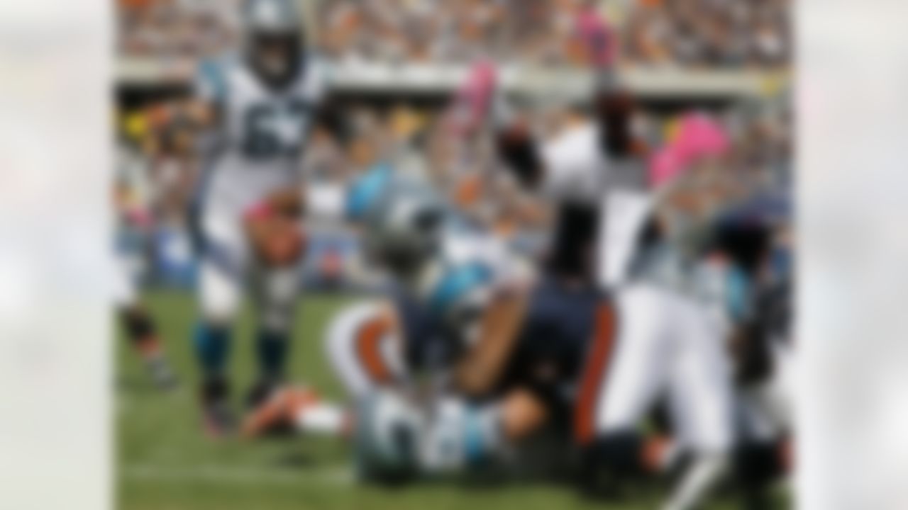Carolina Panthers quarterback Cam Newton (1) rushes 2 yards for a touchdown against the Chicago Bears in the first half of an NFL football game in Chicago, Sunday, Oct. 2, 2011. (AP Photo/Charles Rex Arbogast)