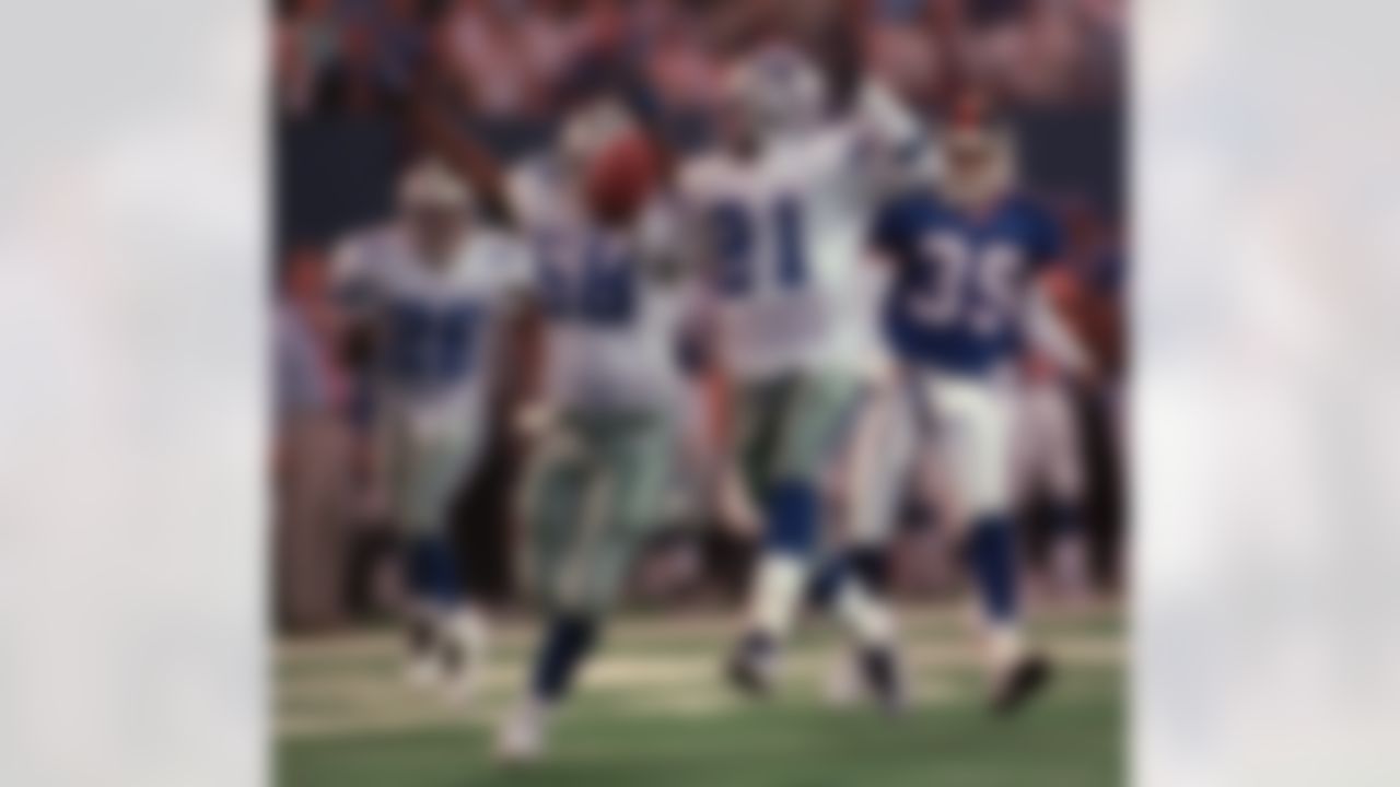 Dallas Cowboys' Deion Sanders heads for the endzone as teammate Nate Hemsley (58) begins the touchdown celebration in the second quarter Monday, Sept. 21, 1998, at Giants Stadium in East Rutherford, N.J. Cowboys' Kevin Smith (26) and New York Giants' Jeremy Lincoln (39) follow behind. (AP Photo/John Geilick)