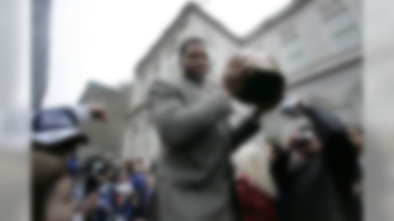 NEW YORK - FEBRUARY 5: New York Giants defensive end Michael Strahan makes his way to the stage carrying the NFC George C. Halas trophy during a ceremony honoring the team February 5, 2008 in New York City. The Giants beat the New England Patriots in Super Bowl XLII 17-14 on Sunday. (Photo by Julie Jacobson-Pool/Getty Images)