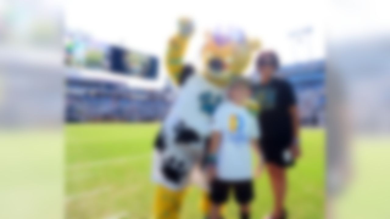 Jacksonville Jaguars mascot Jaxson de Ville with Daily's kick-off kid and Hispanic heritage award winner before kick-off against the Miami Dolphins in an NFL game, Sunday, Sept. 20, 2015, in Jacksonville, Fla. (Rick Wilson/Jacksonville Jaguars)