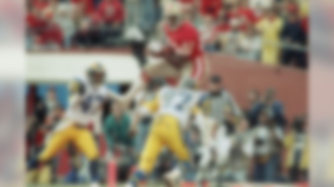 San Francisco 49ers wide receiver John Taylor goes high to haul in a Joe Montana pass for a touchdown between Los Angeles Rams James Washington (37) and LeRoy Irvin (47) in the second quarter at Candlestick Park, Sunday, Jan. 14, 1990, San Francisco, Calif. (AP Photo/Bob Galbraith)