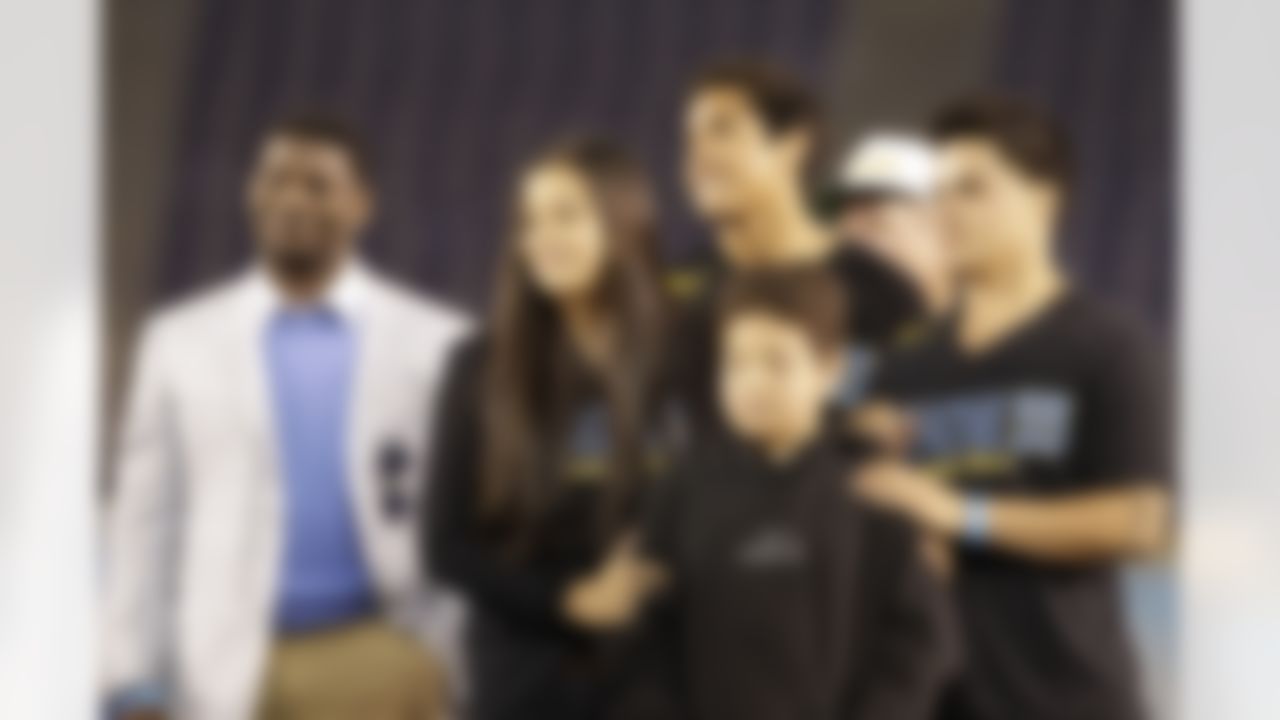 The children of Junior Seau, right, stand on stage alongside running back LaDainian Tomlinson, left, during a public memorial service for football player Junior Seau at Qualcomm Stadium Friday, May 11, 2012, in San Diego. The children are, from right, Tyler, Hunter, Jake and Sydney Seau. Seau committed suicide on May 2 at his Oceanside, Calif., home. He played parts of 20 seasons in the NFL, with the San Diego Chargers, Miami Dolphins and New England Patriots. (AP Photo/ Gregory Bull)