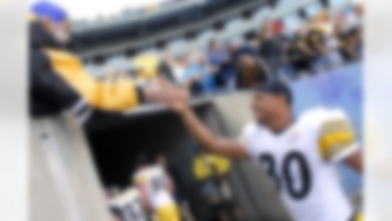 CHARLOTTE, NC - DECEMBER 17: Cedrick Wilson #80 of the Pittsburgh Steelers high-fives a fan after a game against the Carolina Panthers December 17, 2006 at Bank of America Stadium in Charlotte, North Carolina. Pittsburgh defeated Carolina 37-3. Photo by Getty Images.