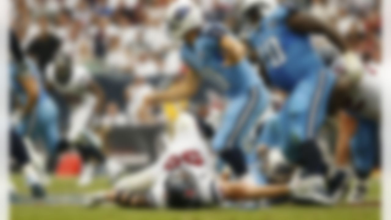 Houston Texans defensive end J.J. Watt (99) tries to bring down Tennessee Titans quarterback Jake Locker (10) during an NFL football game at Reliant Stadium on September 15, 2013 in Houston, Texas. Houston won 30-24. (Aaron M. Sprecher/NFL)