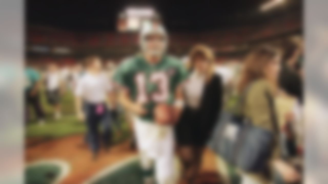 Miami Dolphins quarterback Dan Marino, left, walks off the field with Fudge Brown, of the Dolphins public relations department, after the Dolphins defeated the Kansas City Chiefs 27-17, in Miami, Saturday, Dec. 31, 1994. (AP Photo/Hans Deryk)