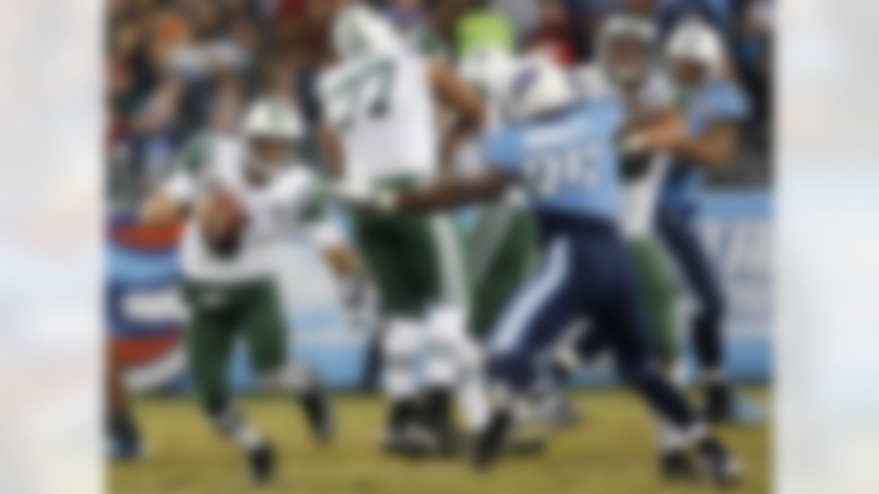 New York Jets quarterback Mark Sanchez (6) scrambles away from Tennessee Titans defensive end Kamerion Wimbley (95) in the second quarter of an NFL football game, Monday, Dec. 17, 2012, in Nashville, Tenn. (AP Photo/Joe Howell)