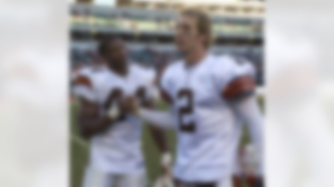 Cleveland Browns quarterback Tim Couch (2) and running back Lee Suggs (44) congratulate each other after they defeated the Cincinnati Bengals, 22-14, Sunday, Dec. 28, 2003, in Cincinnati. Suggs ran for 186 yards and two touchdowns in the game. (AP Photo/Al Behrman)