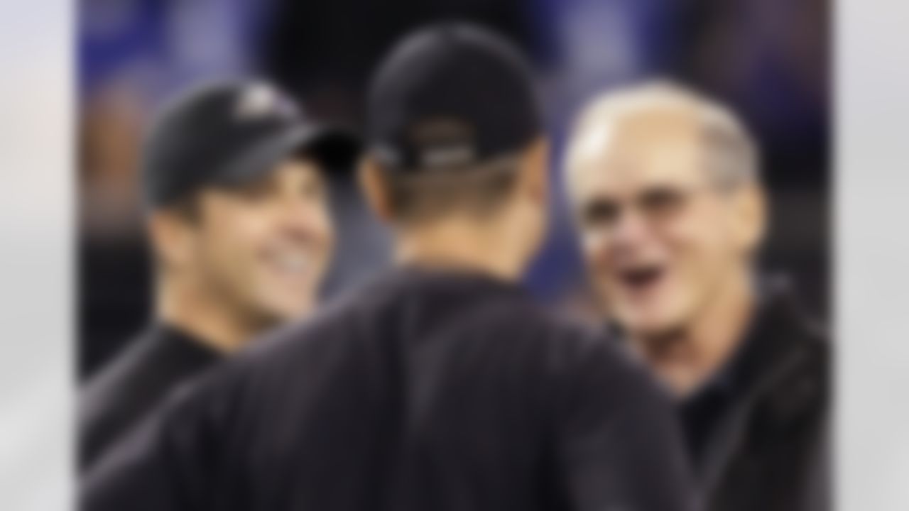 Baltimore Ravens head coach John Harbaugh, left, and his brother, San Francisco 49ers head coach Jim Harbaugh, talk with their father, Jack, right, before their NFL football game in Baltimore on November 24, 2011. (AP Photo/Patrick Semansky)