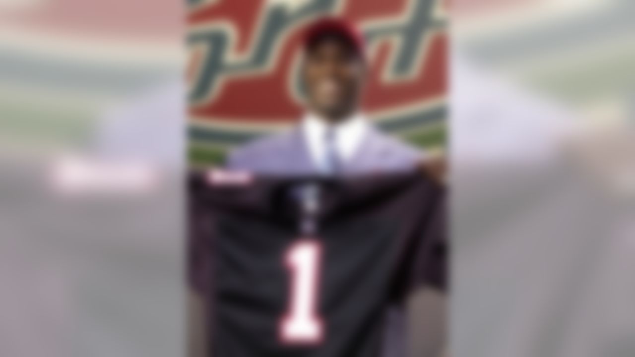 Quarterback Michael Vick of Virginia Tech holds up an Atlanta Falcons jersey after being picked No. 1 overall in the NFL draft on Saturday, April 21, 2001 in New York.