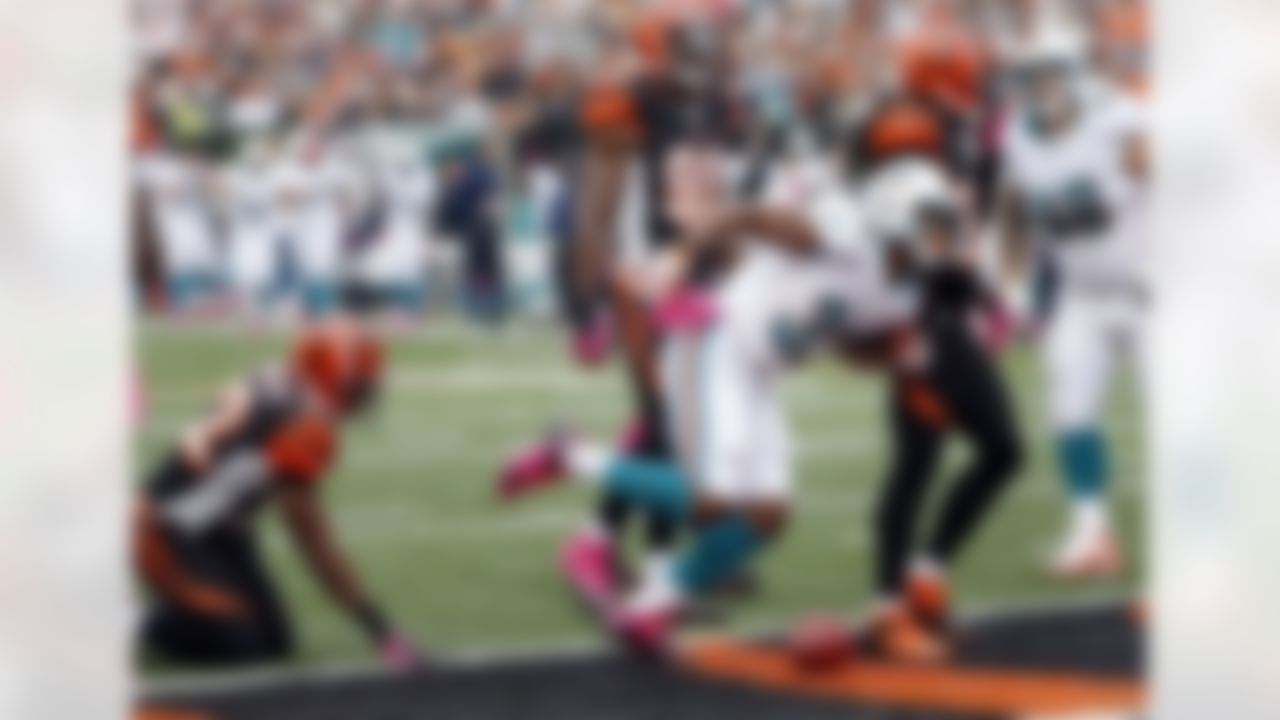 Miami Dolphins running back Daniel Thomas (33) scores a second quarter touchdown that gives the Dolphins a 7-6 lead during the NFL week 5 football game against the Cincinnati Bengals on Sunday, Oct. 7, 2012 in Cincinnati. The Dolphins won the game 17-13. (AP Photo/Paul Spinelli)