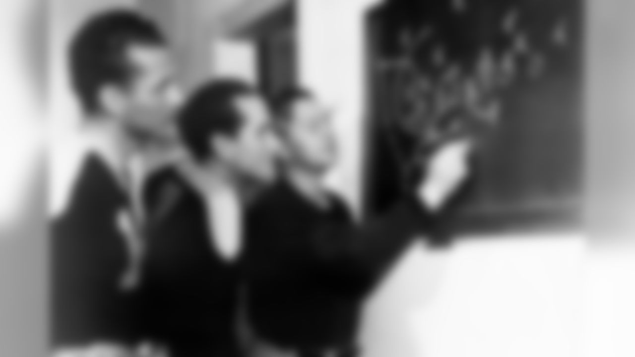 Green Bay Packers Hall of Fame head coach Earl "Curly " Lambeau diagrams a play on the chalkboard for quarterback Cecil Isbell and Hall of Fame end Don Hutson in 1940. (Pro Football Hall Of Fame)