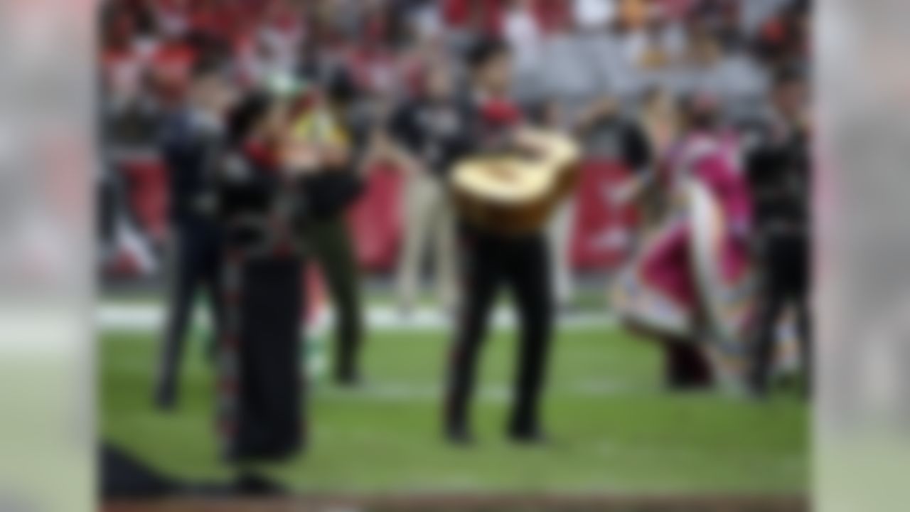 The Alma De Musica & Danza perform at half time of the Tampa Bay Buccaneers and the Arizona Cardinals football game in celebration of Hispanic heritage month Sunday, Sept. 18, 2016, in Glendale, Ariz. (AP Photo/Rick Scuteri)