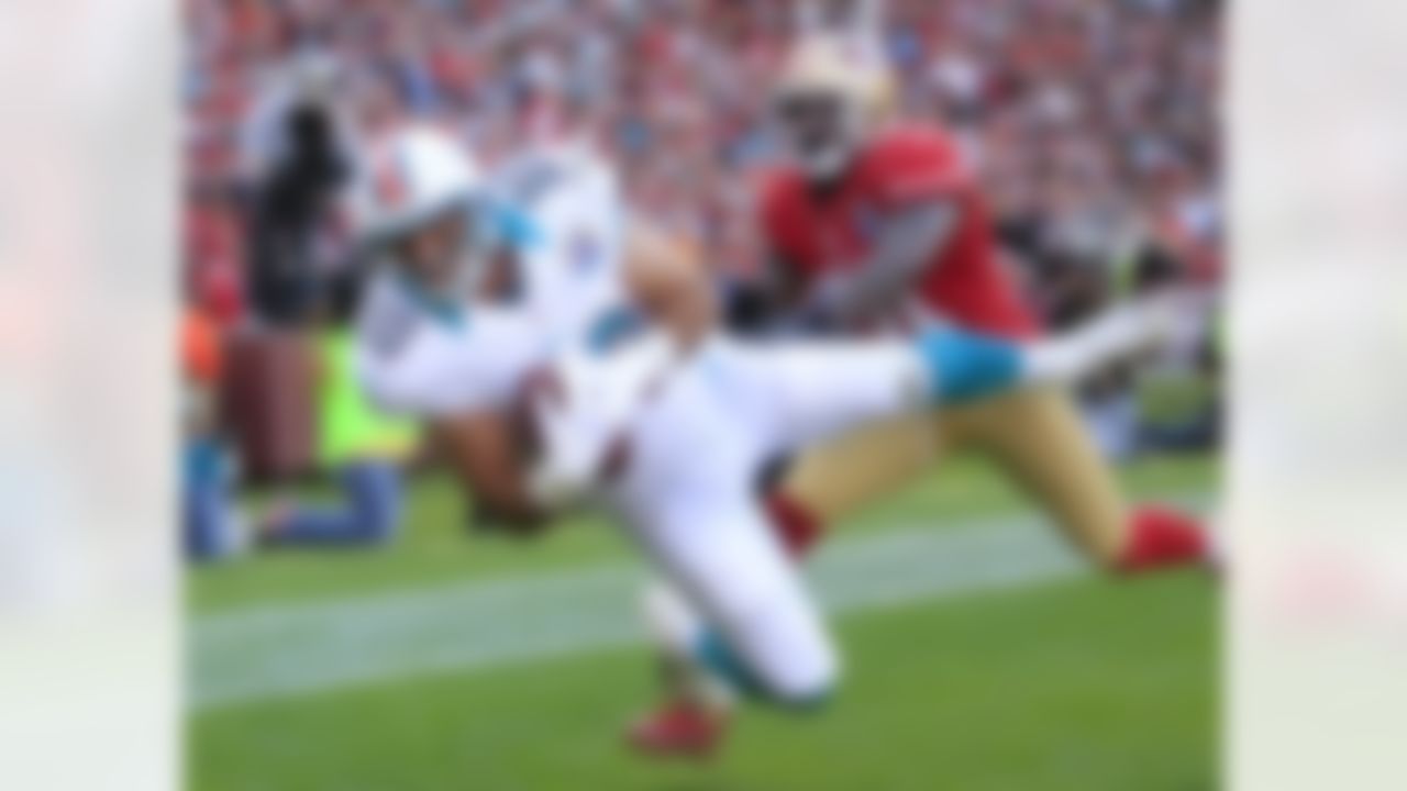 Miami Dolphins tight end Anthony Fasano falls into the end zone for a touchdown on a three-yard pass quarterback Ryan Tannehill as San Francisco 49ers strong safety Donte Whitner, right, looks on during the fourth quarter of an NFL football game in San Francisco, Sunday, Dec. 9, 2012. (AP Photo/Ben Margot)