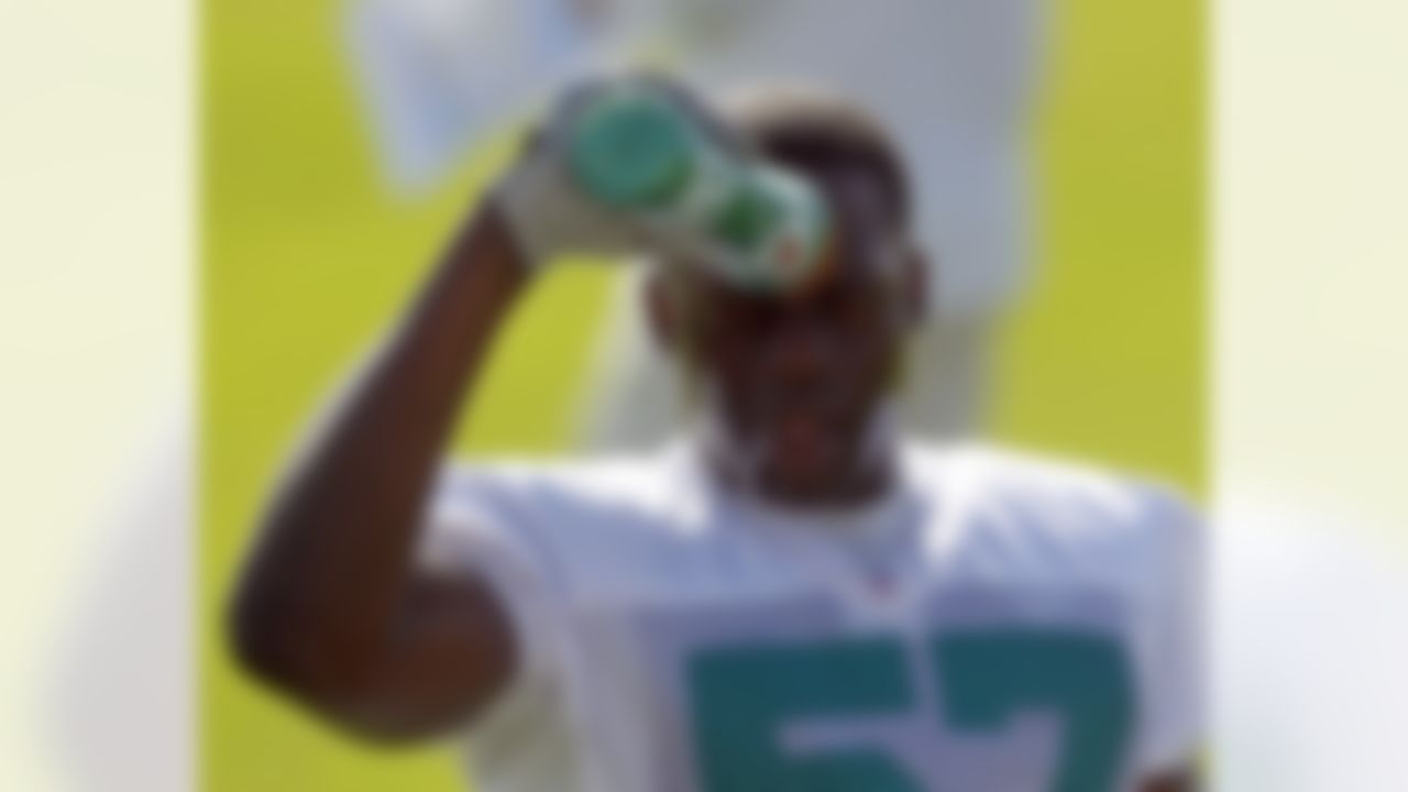 Miami Dolphins' Josh Kaddu cools off at practice during NFL football training camp in Davie, Fla., Friday, July 27, 2012. (AP Photo/Alan Diaz)