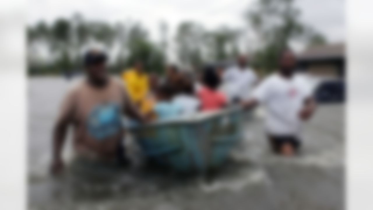 Rescuers use an old rowboat to evacuate children and an elderly woman from their flooded homes in Gulfport, Miss., after Hurricane Katrina struck the Gulf Coast on Monday, Aug. 29, 2005. (AP Photo/John Bazemore)