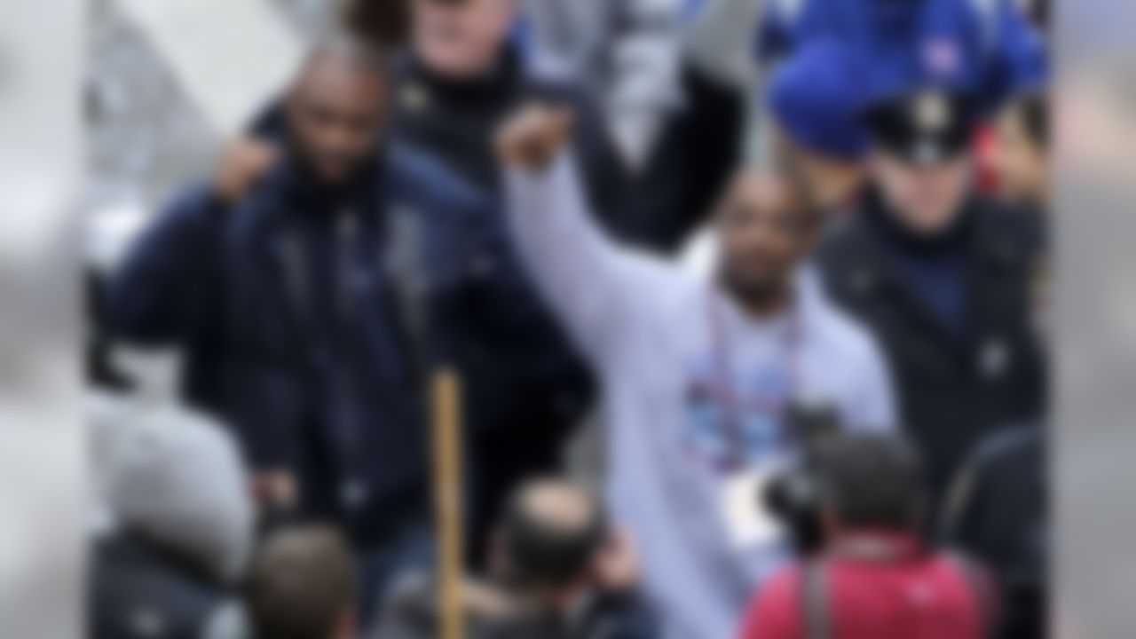 New York Giants' Brandon Jacobs, left, and Ahmad Bradshaw greet fans after jumping off their float during the team's NFL football Super Bowl parade in New York, Tuesday, Feb. 7, 2012. The Giants returned from their Super Bowl win to a celebration the likes that only New York can throw: a ticker-tape parade in the Canyon of Heroes on Broadway, where the city has honored stars for almost a century. (AP Photo/Seth Wenig)