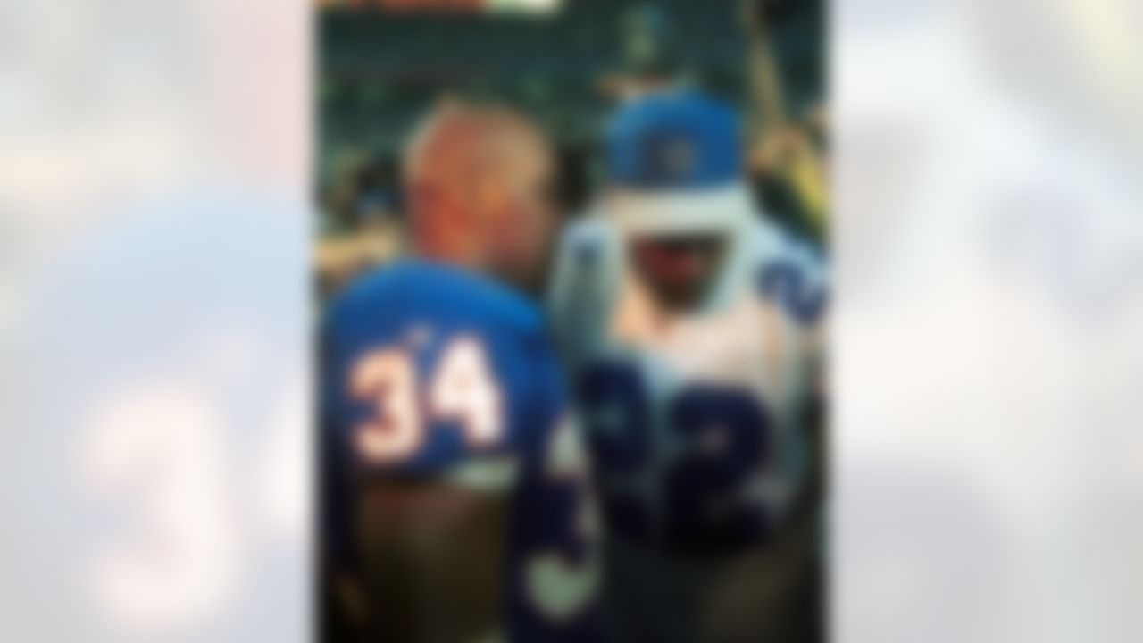 Buffalo Bills running back Thurman Thomas (34) and Super Bowl XXVIII MVP Emmitt Smith of Dallas Cowboys (22) embrace after the Dallas Cowboys 30-13 victory over the Buffalo Bills at the Georgia Dome on January 30, 1994 in Atlanta, Georgia. (Associated Press)