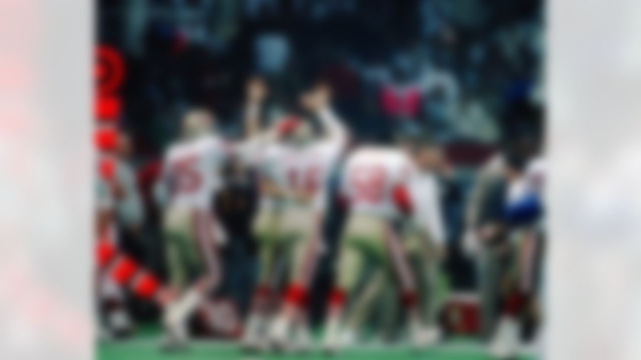 San Francisco 49ers Hall of Fame quarterback Joe Montana (16) is congratulated by his teammates after throwing a touchdown pass during a Super Bowl XXIV NFL game against the Denver Broncos in New Orleans, on January 28, 1990. The 49ers defeated the Broncos 55-10. (AP Photo/Eric Lars Bakke)