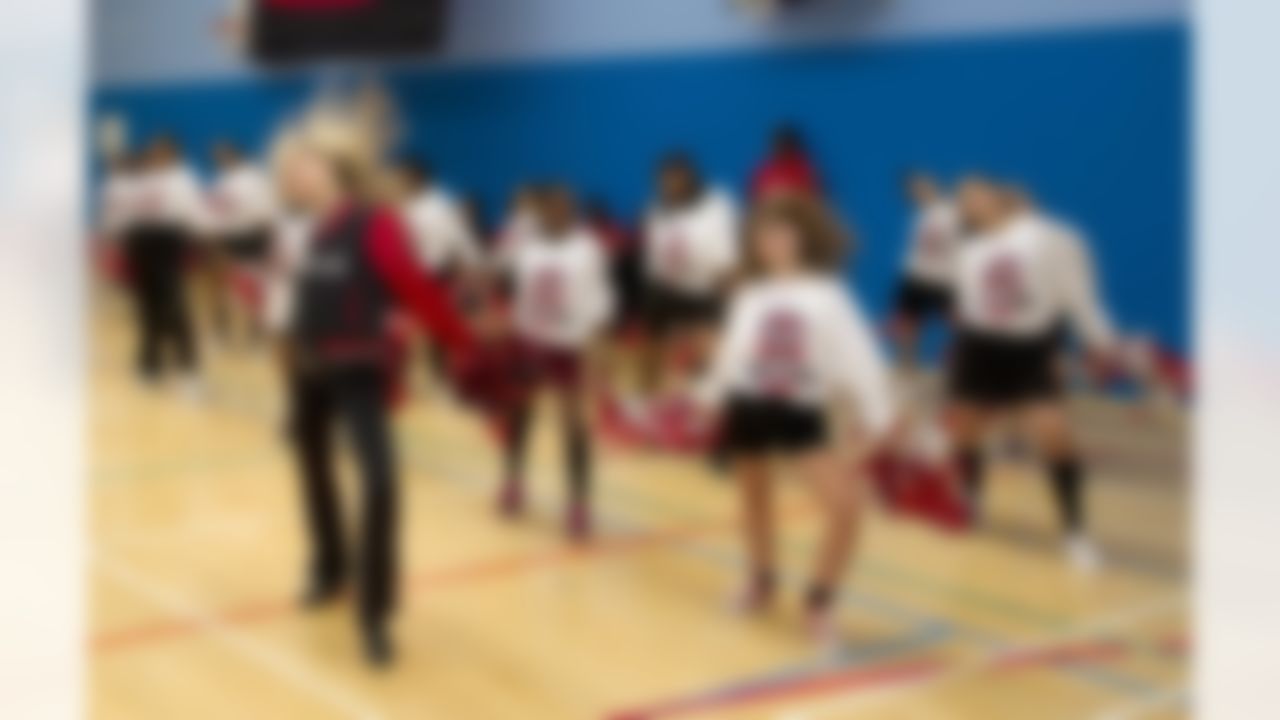 A Tampa Bay Buccaneers cheerleader performs with students at the Harris Academy on October 18, 2011 in London, England. (Sean Ryan/NFL)