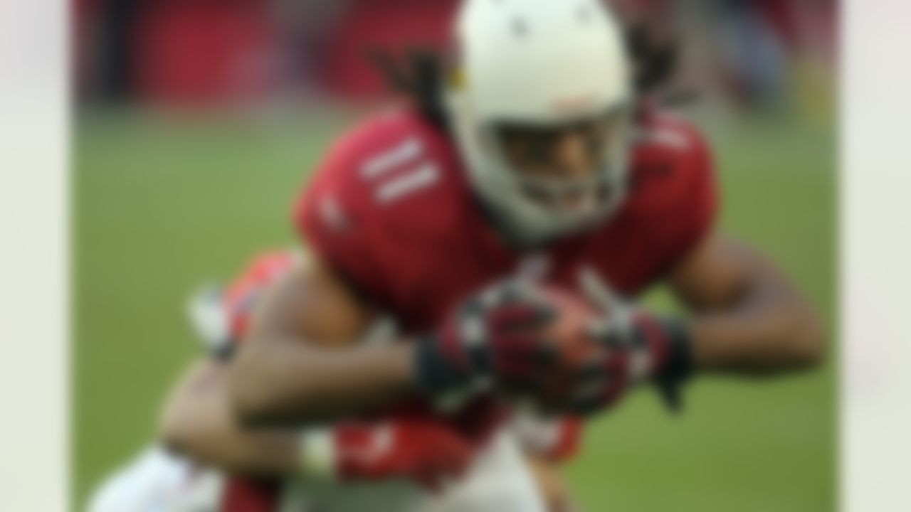 GLENDALE, AZ - DECEMBER 23: Larry Fitzgerald #11 of the Arizona Cardinals is tackled by Brent Grimes #43 of the Atlanta Falcons during the third quarter at University of Phoenix Stadium on December 23, 2007 in Glendale, Arizona. The Cardinals won 30-27 in overtime. (Photo by Harry How/Getty Images)
