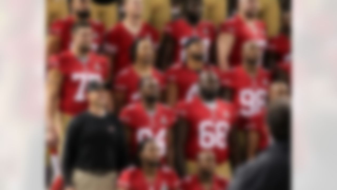 San Francisco 49ers head coach Jim Harbaugh (lower left) stands next to wide receiver Randy Moss #84 during the team photo the Super Bowl XLVII Media Day at the Superdome on Tuesday, January 29, 2013 in New Orleans, LA. (Perry Knotts/NFL)