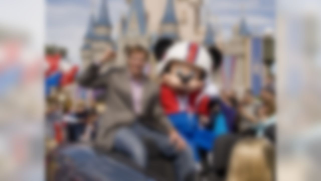 In this Monday, Feb. 8, 2010 photo released by Disney, Super Bowl XLIV MVP, New Orleans Saints quarterback Drew Brees joins Mickey Mouse in a parade in the Magic Kingdom in Lake Buena Vista, Fla., celebrating the Saints' 31-17 victory over the Indianapolis Colts in Sunday's Super Bowl. (AP Photo/Disney, David Roark)