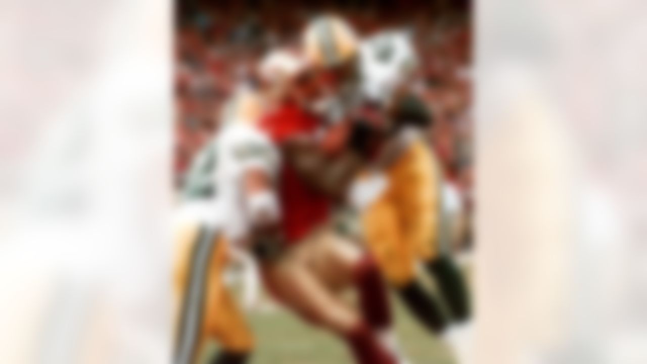 San Francisco 49ers' wide receiver Terrell Owens pulls in a 25-yard touchdown pass from quarterback Steve Young as Green Bay Packers' safeties Pat Terrell (40) and Darren Sharper defend late in the fourth quarter of the NFC wild card playoff game at 3COM Park in San Francisco, Sunday, Jan. 3, 1999. Owens' catch with three seconds left in the game led the 49ers 30-27. (AP Photo/Susan Ragan)