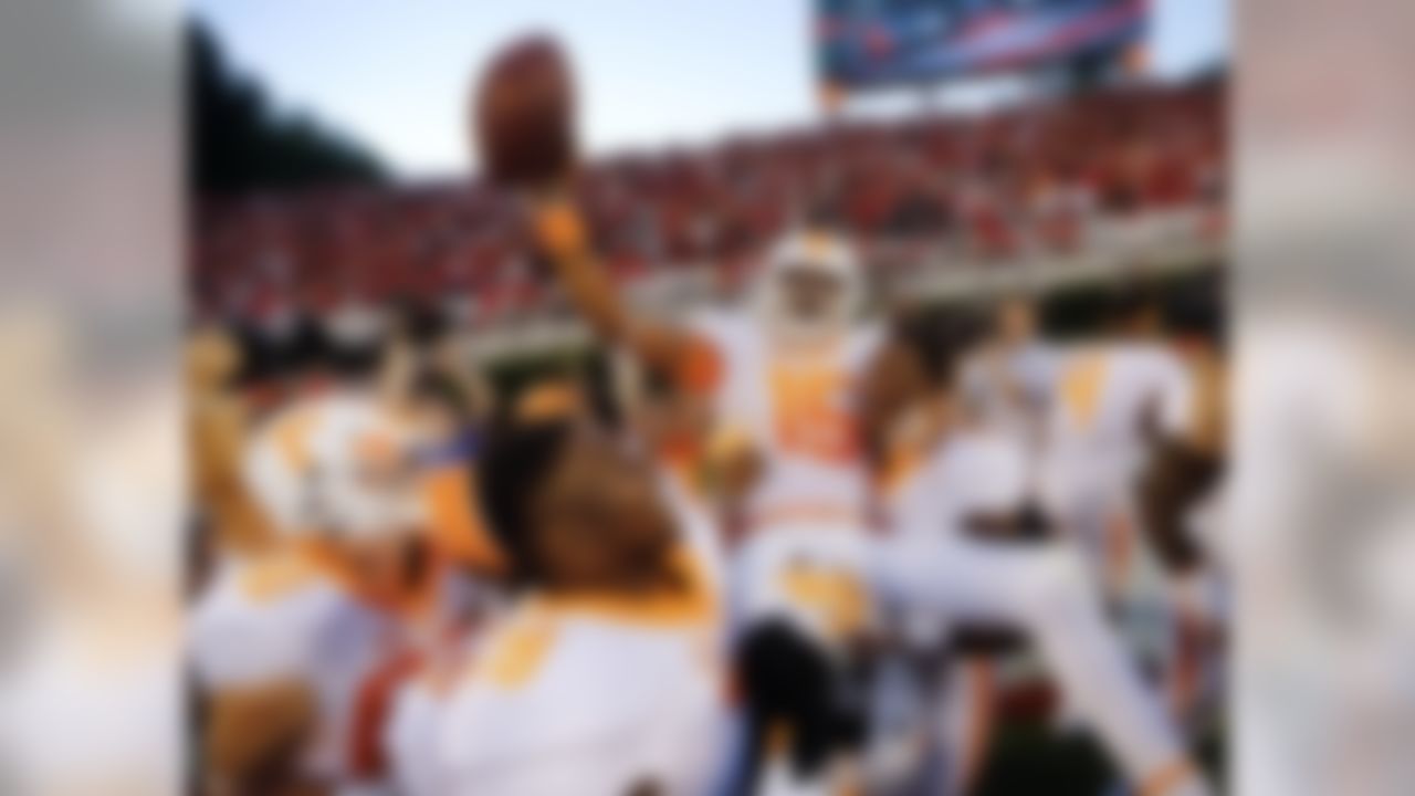 Tennessee wide receiver Jauan Jennings (15) is carried by teammates Kyle Phillips (5) and Charles Mosley (78) after making a last-second touchdown catch to defeat Georgia 34-31 in an NCAA college football game Saturday, Oct. 1, 2016, in Athens, Ga. (AP Photo/John Bazemore)