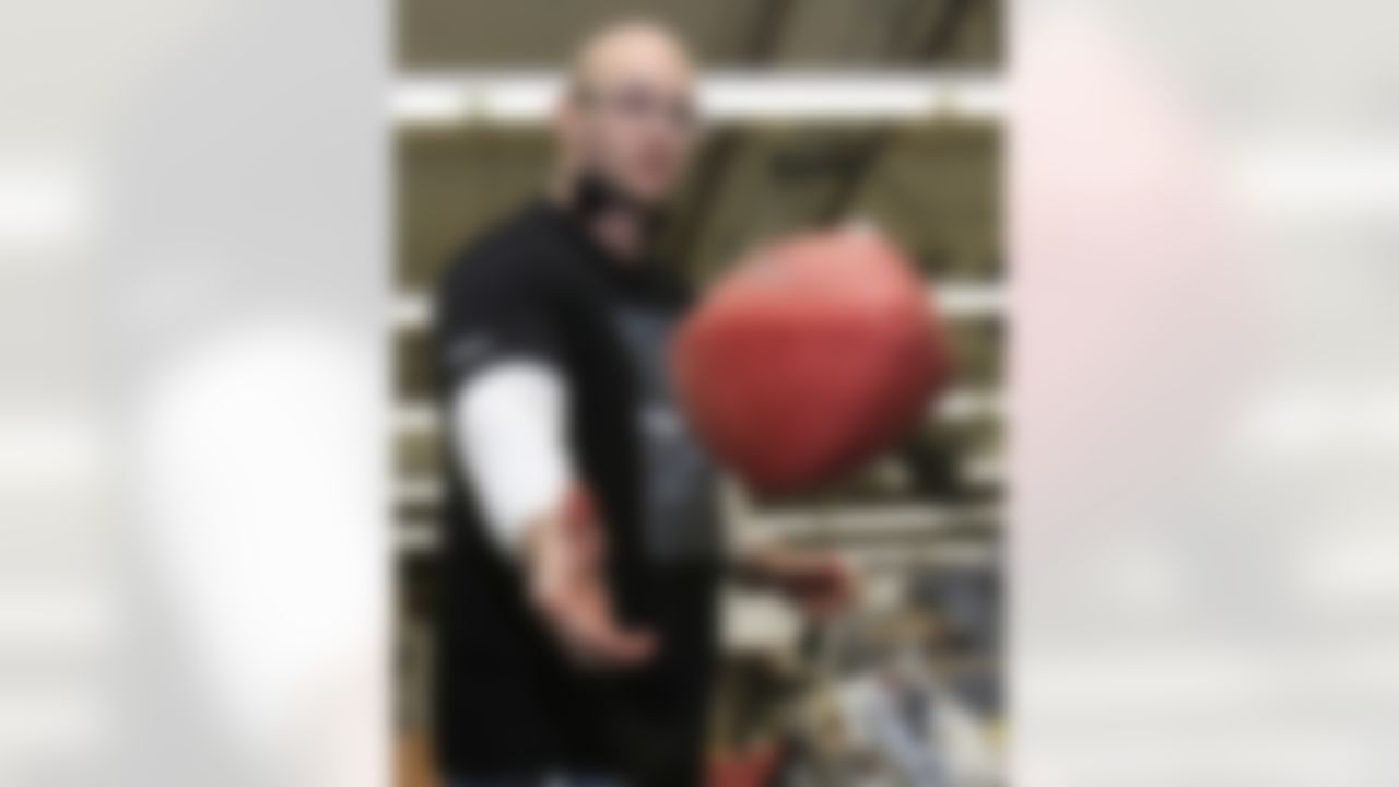 Aaron Plummer tosses a ball into a bin after lacing an official game ball for the NFL football Super Bowl XLVI at Wilson Sporting Goods Co. in Ada, Ohio, Monday, Jan. 23, 2012. The New England Patriots will play the New York Giants in the Super Bowl on Feb. 5 in Indianapolis. (AP Photo/Tony Dejak)