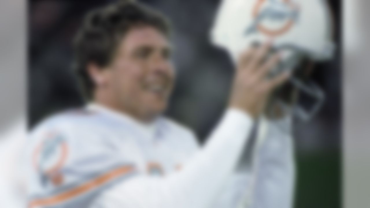 Miami Dolphins quarterback Dan Marino removes his helmet after throwing the winning touchdown against the New York Jets during fourth quarter action at Giants Stadium, Sunday, Nov. 27, 199, East Rutherford, N.J. The Dolphins defeated the Jets 28-24. (AP Photo/Eric Miller)