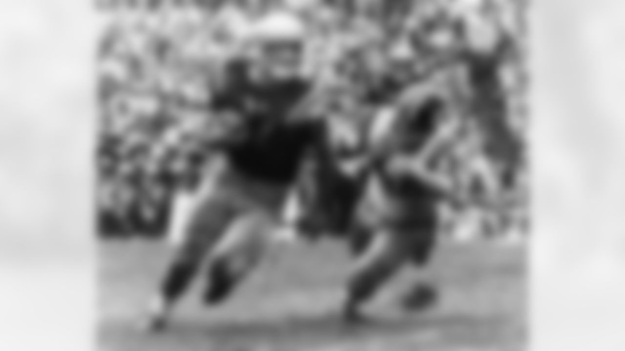 Navy halfback Joe Bellino (27) tries right end but losses a yard in third quarter of game with Missouri on Jan. 2, 1961 in Miami at the Orange Bowl. In pursuit is Missouri guard Paul Henley (68). Missouri won 21-14. (Associated Press)