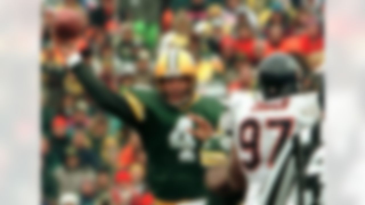 Green Bay Packers quarterback Brett Favre (4) throws a pass past Chicago Bears' Chris Zorich (97) in a light snowfall during the second quarter Sunday, Nov. 12, 1995, in Green Bay, Wis. Favre threw five touchdown passes in the Packers 35-28 win. Favre was 25 of 33 for 336 yards. (AP Photo/Morry Gash)