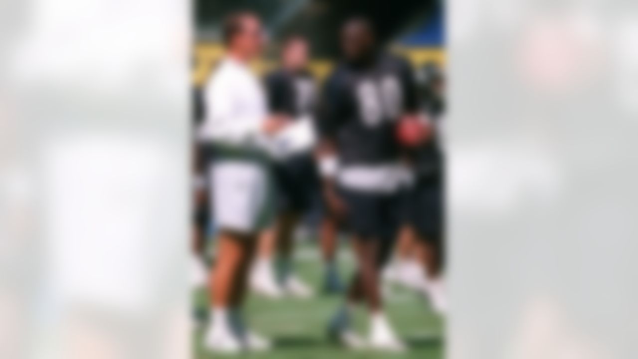 Pittsburgh Steelers' Plaxico Burress, right, talks with head coach Bill Cowher, left, during a practice session in Mexico City Friday, Aug. 18, 2000. The Steelers face the Indianapolis Colts Saturday in a preseason game. (AP Photo/Claudio Cruz)
