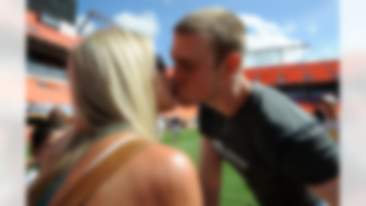 Aug. 4, 2012; Miami, FL, USA; Miami Dolphins quarterback Ryan Tannehill (right) kisses his wife Lauren Ufer (left) after a teams scrimmage at Sun Life Stadium. Mandatory Credit: Steve Mitchell-US PRESSWIRE
