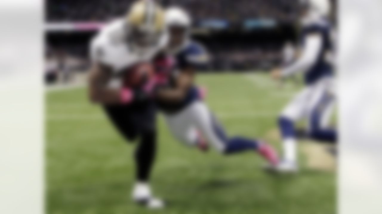 New Orleans Saints wide receiver Marques Colston (12) pulls in a touchdown pass in front of San Diego Chargers cornerback Marcus Gilchrist (38) in the first half of an NFL football game at Mercedes-Benz Superdome in New Orleans, Sunday, Oct. 7, 2012. (AP Photo/Bill Haber)