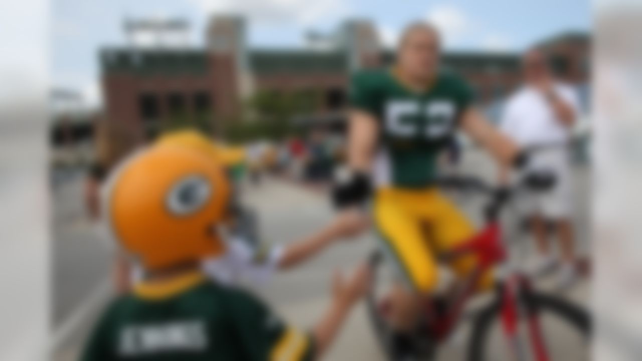 Rookie Clay Matthews rides a bike to the Green Bay Packers' training camp on Saturday, Aug. 1, 2009, in Green Bay, Wis.